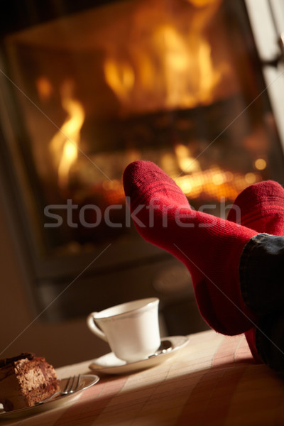 Close Up Of Mans Feet Relaxing By Cosy Log Fire With Tea And Cak Stock photo © monkey_business