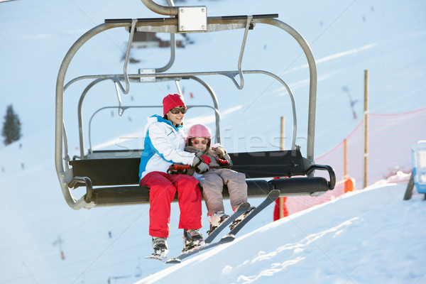 Mother And Daughter Getting Off chair Lift On Ski Holiday In Mou Stock photo © monkey_business