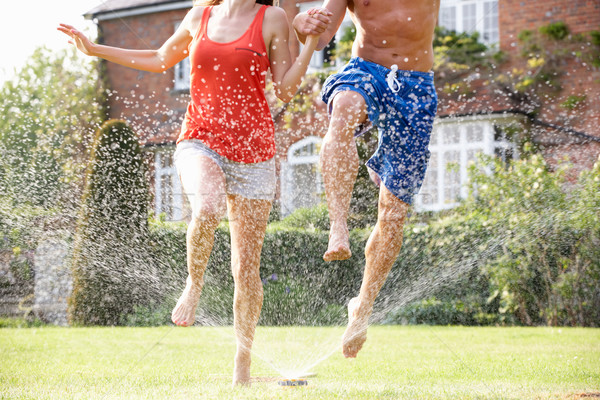 Paar läuft Garten Sprinkler Frau Wasser Stock foto © monkey_business
