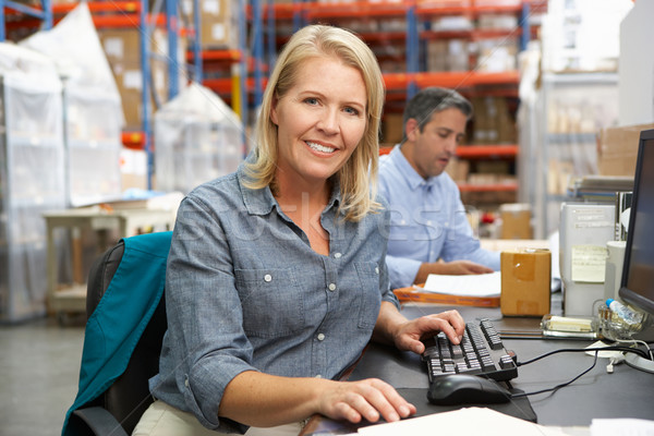 Businesswoman Working At Desk In Warehouse Stock photo © monkey_business