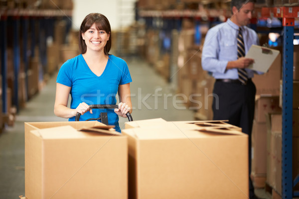 Female Worker Pulling Pallet In Warehouse Stock photo © monkey_business
