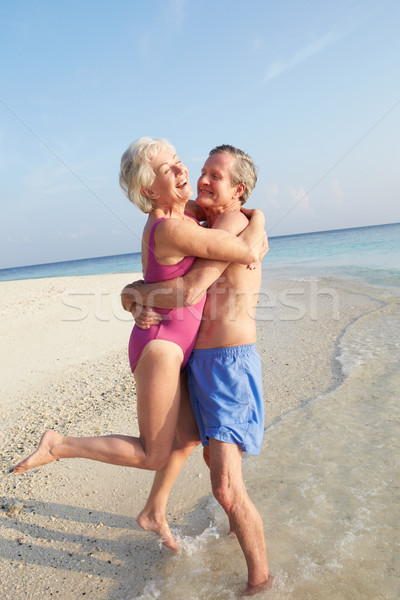 Senior Couple Having Fun On Tropical Beach Holiday Stock photo © monkey_business