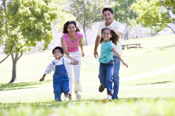 Family running outdoors holding hands and smiling Stock photo © monkey_business