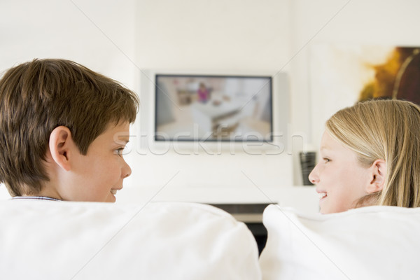 Young boy and young girl in living room with flat screen televis Stock photo © monkey_business