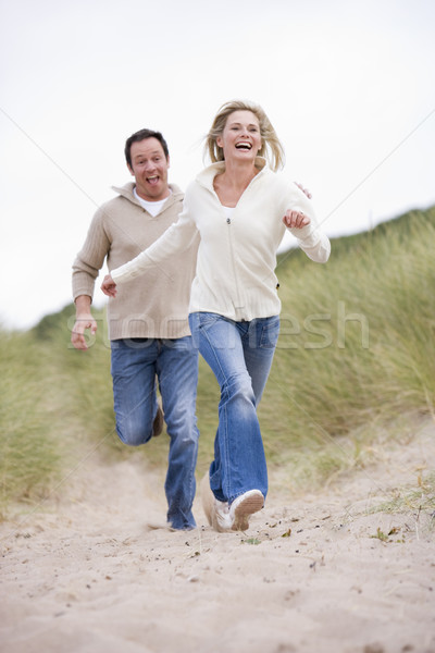 Couple running at beach smiling Stock photo © monkey_business