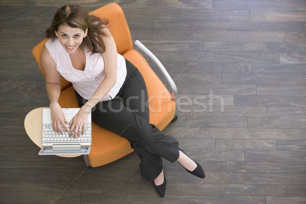 üzletasszony ül bent laptop mosolyog férfi Stock fotó © monkey_business