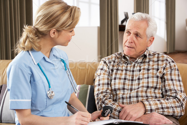 Stock photo: Senior Man Talking To Health Visitor At Home