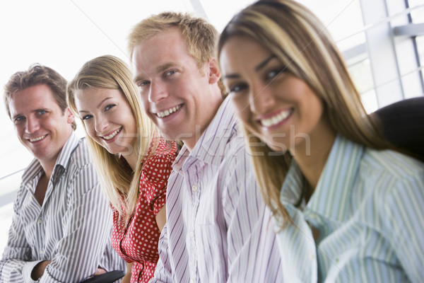 Stock photo: Four businesspeople sitting indoors smiling