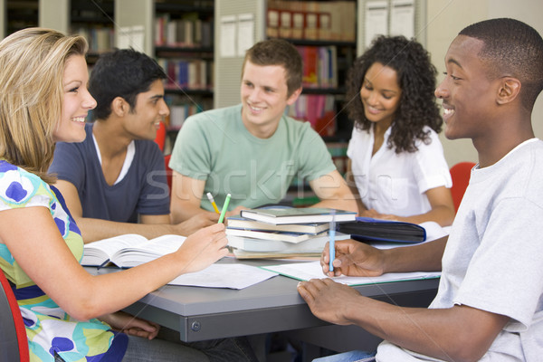 College students studying together in a library Stock photo © monkey_business