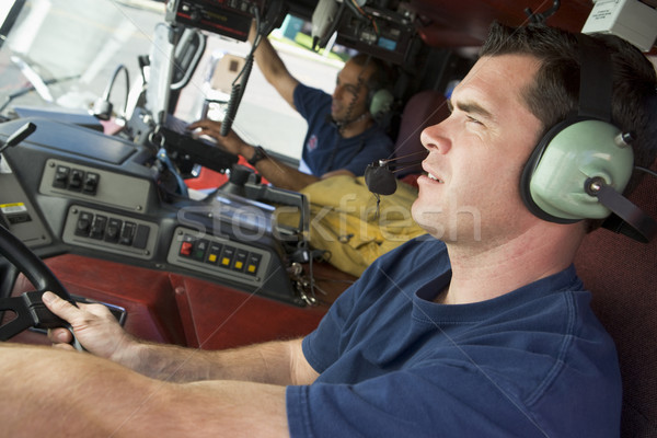 Feuerwehrmann fahren Feuerwehrauto T-Shirt Farbe Headset Stock foto © monkey_business