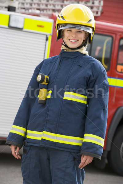 Portrait of a firefighter standing in front of a fire engine Stock photo © monkey_business