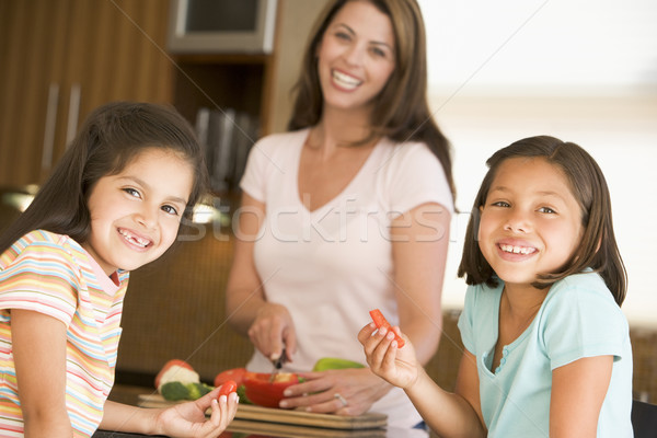 Girls Eating Pepper Strips While Mother Is Preparing meal,mealti Stock photo © monkey_business