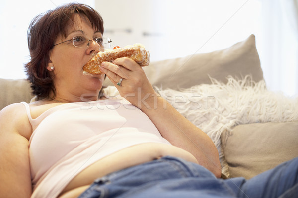 Overweight Woman Relaxing On Sofa Stock photo © monkey_business