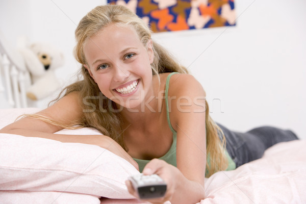 Teenage Girl Lying On Her Bed Changing Television Channels Stock photo © monkey_business