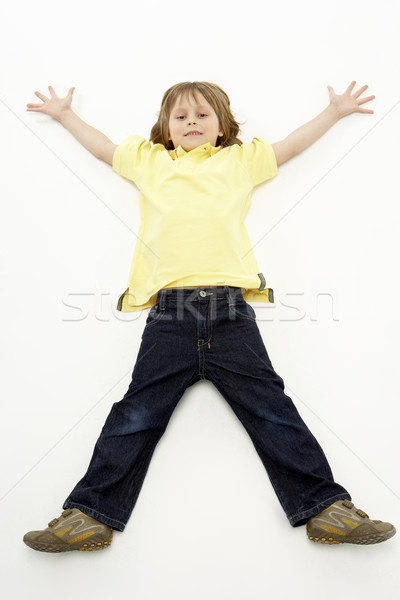 Studio portrait souriant garçon couché bras [[stock_photo]] © monkey_business