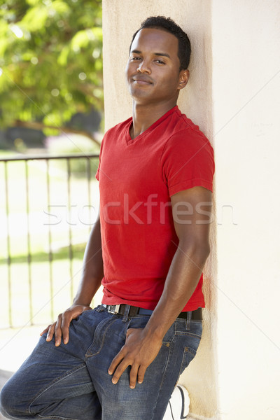 Stock photo: Young Man Leaning Against Pillar