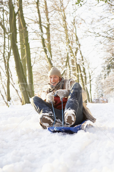 Man Sledging Through Snowy Woodland Stock photo © monkey_business