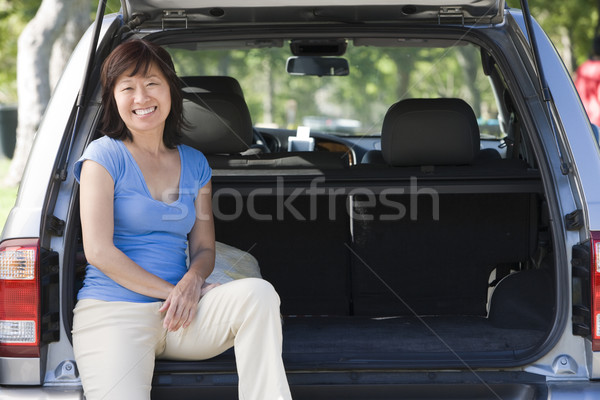 Woman sitting in back of van smiling Stock photo © monkey_business