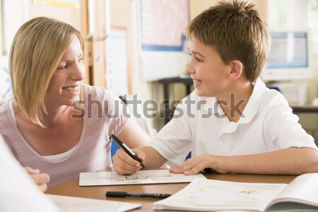 A teacher instructs a schoolgirl in a high school class Stock photo © monkey_business