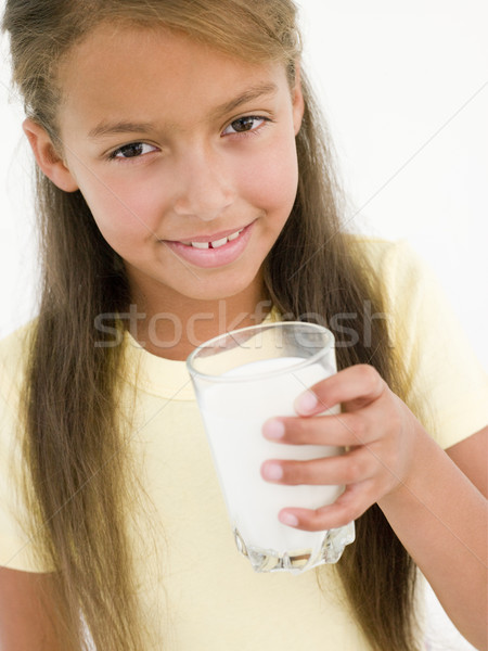 Stock photo: Young girl with glass of milk smiling