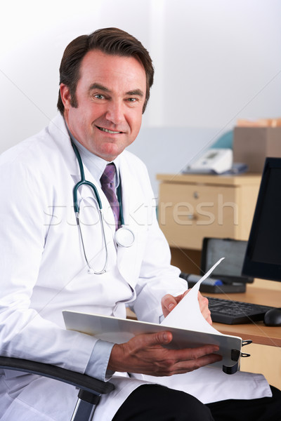 Portrait American doctor sitting at desk Stock photo © monkey_business