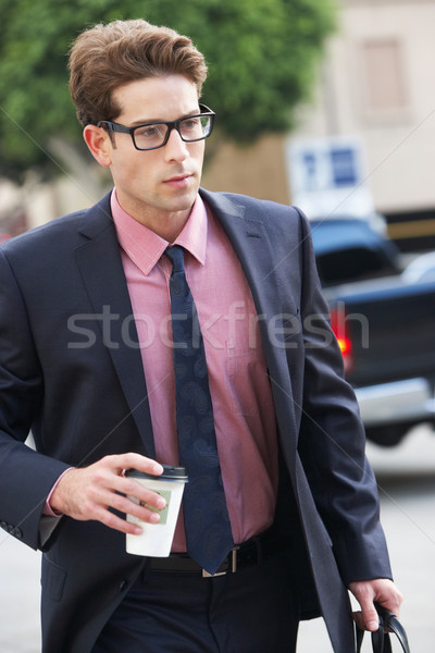 Businessman Hurrying Along Street Holding Takeaway Coffee Stock photo © monkey_business
