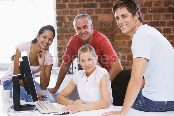 Four businesspeople in office space smiling Stock photo © monkey_business