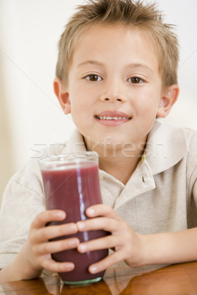 Young boy indoors drinking juice smiling Stock photo © monkey_business