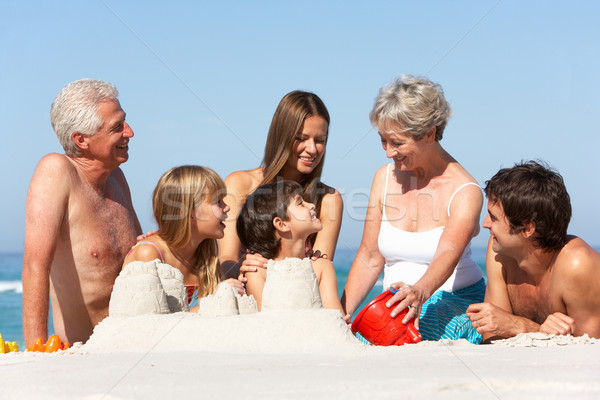 Three Generation Family Building Sandcastles On Beach Holiday Stock photo © monkey_business