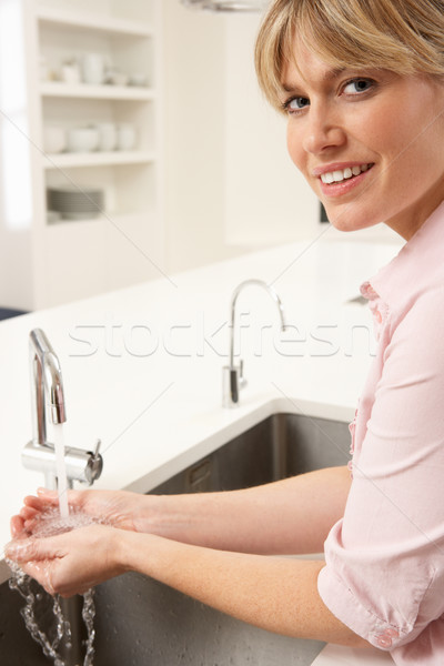 Woman Washing Hands At Kitchen Sink Stock photo © monkey_business