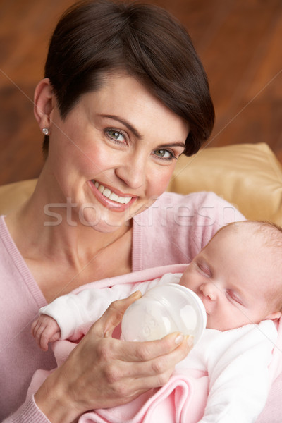 Stock photo: Portrait Of Mother Feeding Newborn Baby At Home