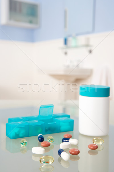 Pills and organiser in bathroom Stock photo © monkey_business