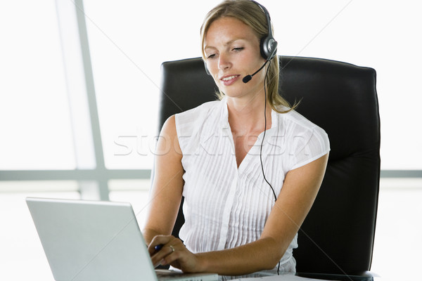 üzletasszony ül iroda visel headset laptopot használ Stock fotó © monkey_business