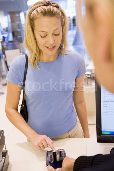 Female customer enetring PIN number Stock photo © monkey_business