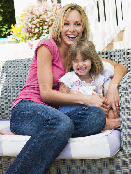 Stock photo: Woman and young girl sitting on patio laughing