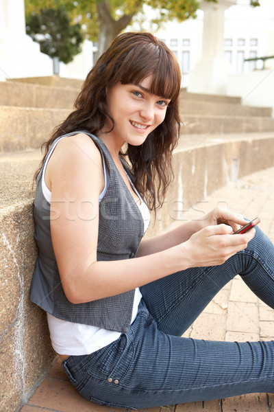 Teenage Student Sitting Outside On College Steps Using Mobile Ph Stock photo © monkey_business