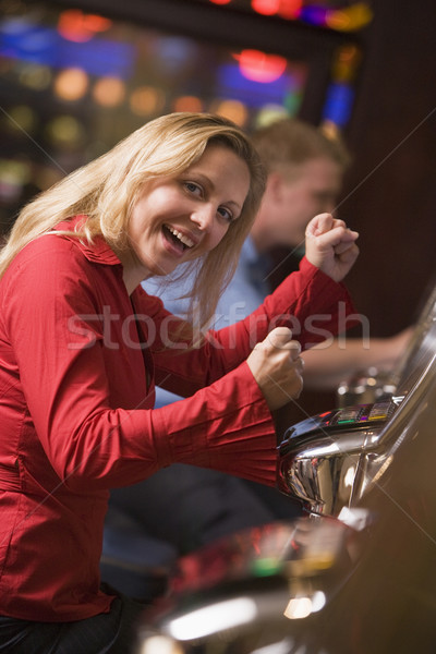 Woman celebrating win at slot machine Stock photo © monkey_business