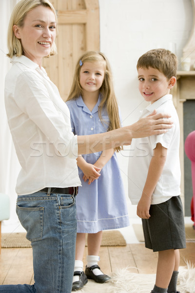 Stock photo: Woman in front hallway with two young children smiling