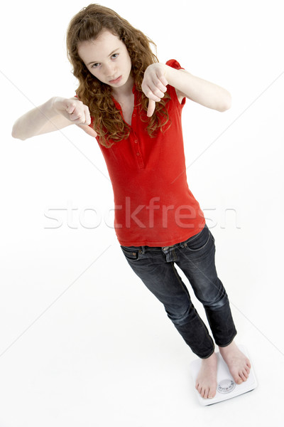 Unhappy Young Girl Standing On Scales Stock photo © monkey_business