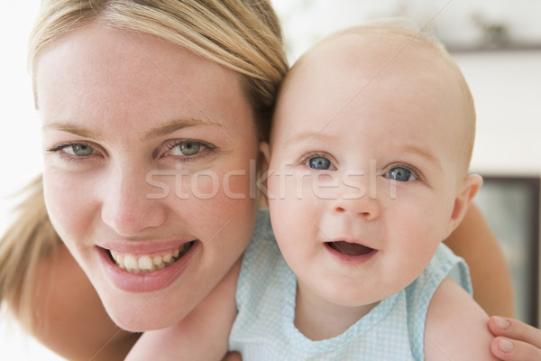 Mother in living room with baby smiling Stock photo © monkey_business