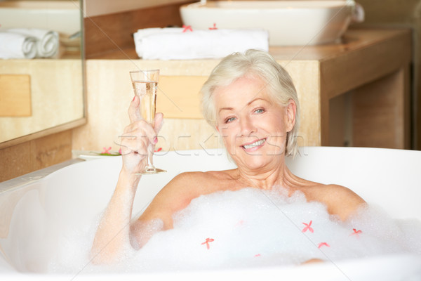 Senior Woman Relaxing In Bath Drinking Champagne Stock photo © monkey_business