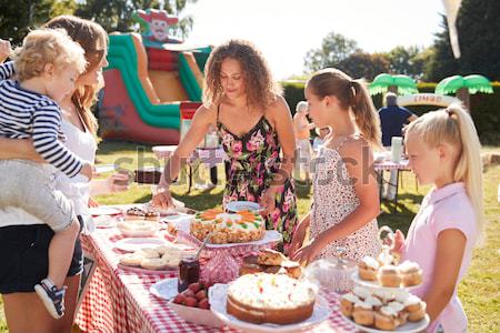 Young children at party sitting at table with food smiling Stock photo © monkey_business