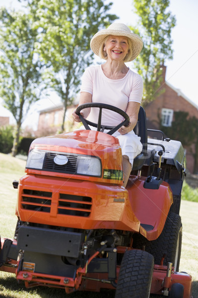 Woman outdoors driving lawnmower smiling Stock photo © monkey_business