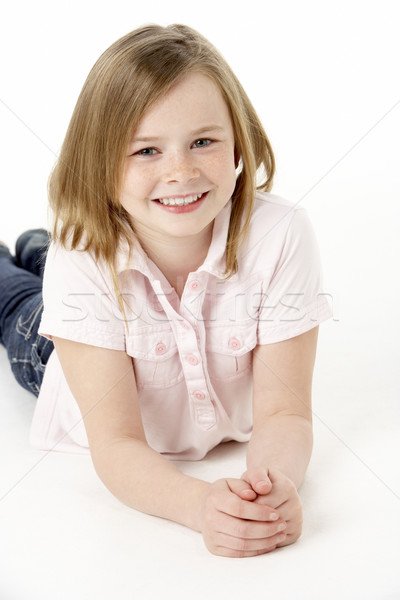 Stock photo: Young Girl Lying On Stomach In Studio