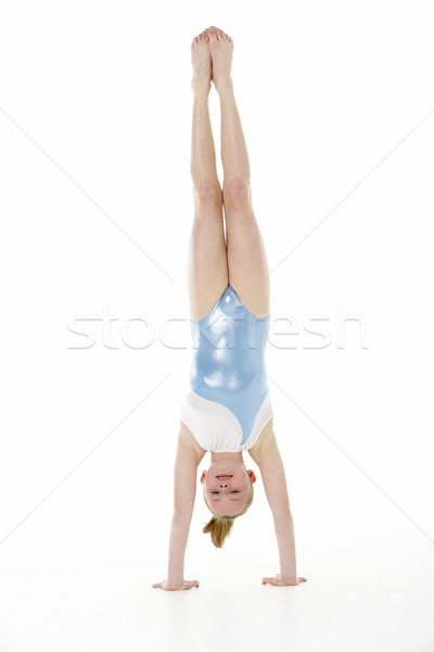 Stock photo: Studio Portrait Of Young Female Gymnast Doing Handstand