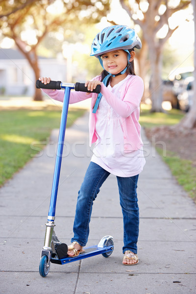 Girl Wearing Safety Helmet Riding Scooter Stock photo © monkey_business