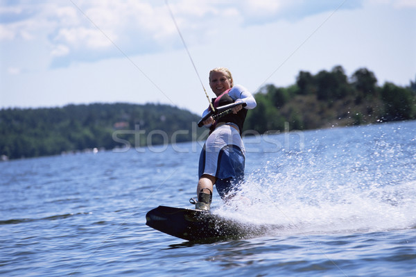 Stock photo: A young woman water skiing