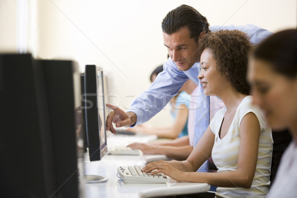 Stock photo: Man assisting woman in computer room