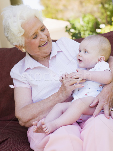 Stock photo: Grandmother outdoors on patio with baby smiling