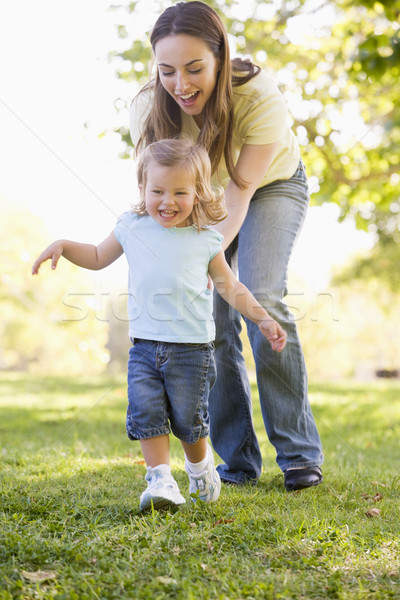 Mother and daughter playing outdoors smiling Stock photo © monkey_business